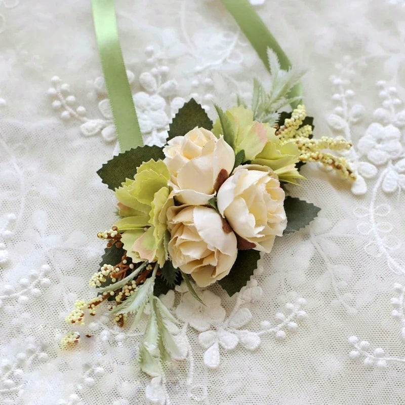 Step into a world of grace and elegance with this stunning beige silk rose wrist corsage. Let its delicate petals speak volumes about your refined taste and style.
