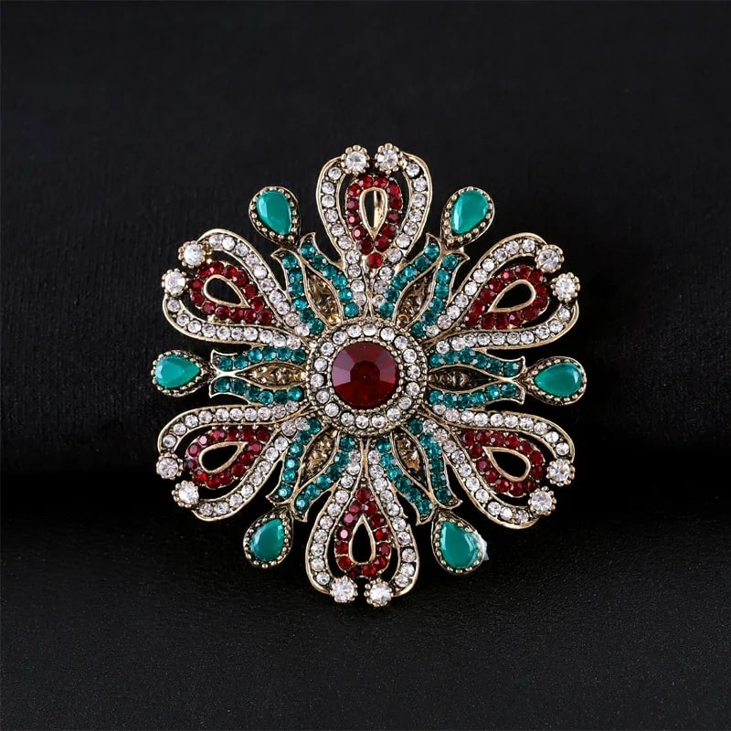 baroque style vintage brooch adorned with red and green stones