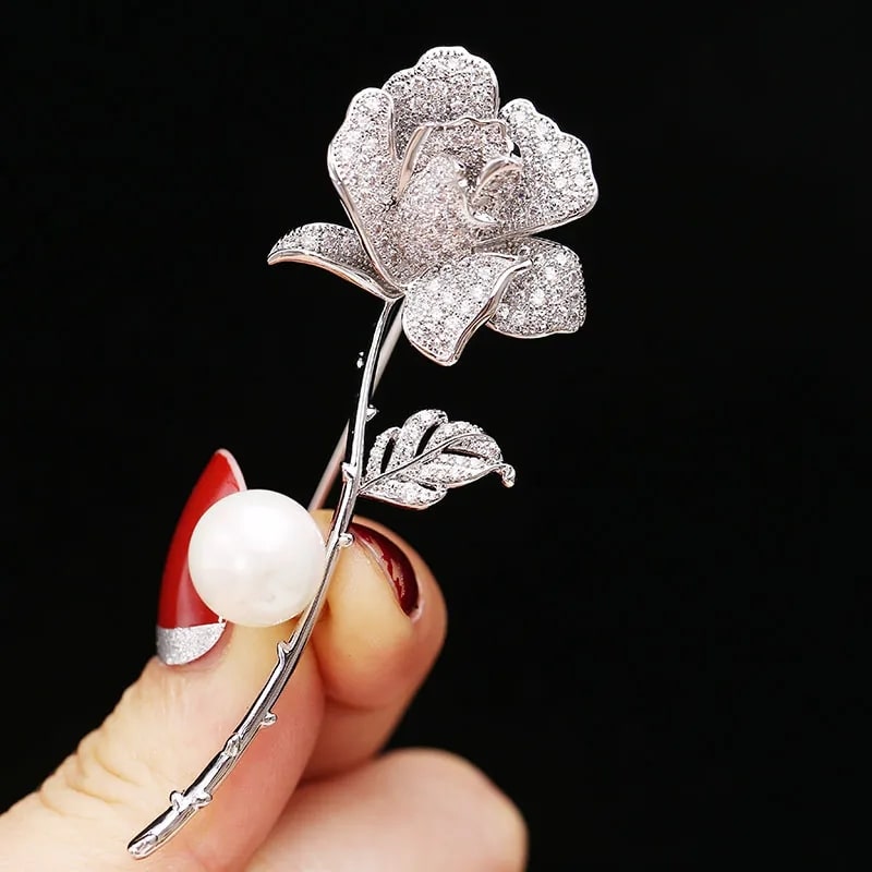 woman holding a rose and pearl brooch treat yourself to our camellia copper inlaid cubic zirconia flower brooch