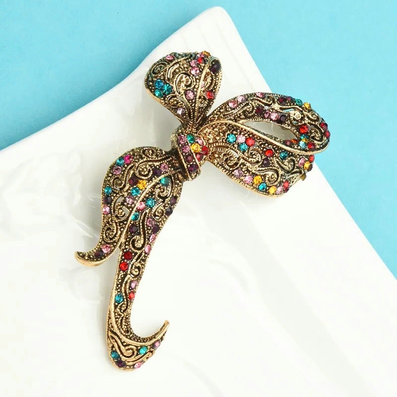 vintage gold bow brooch with multi-colored stones