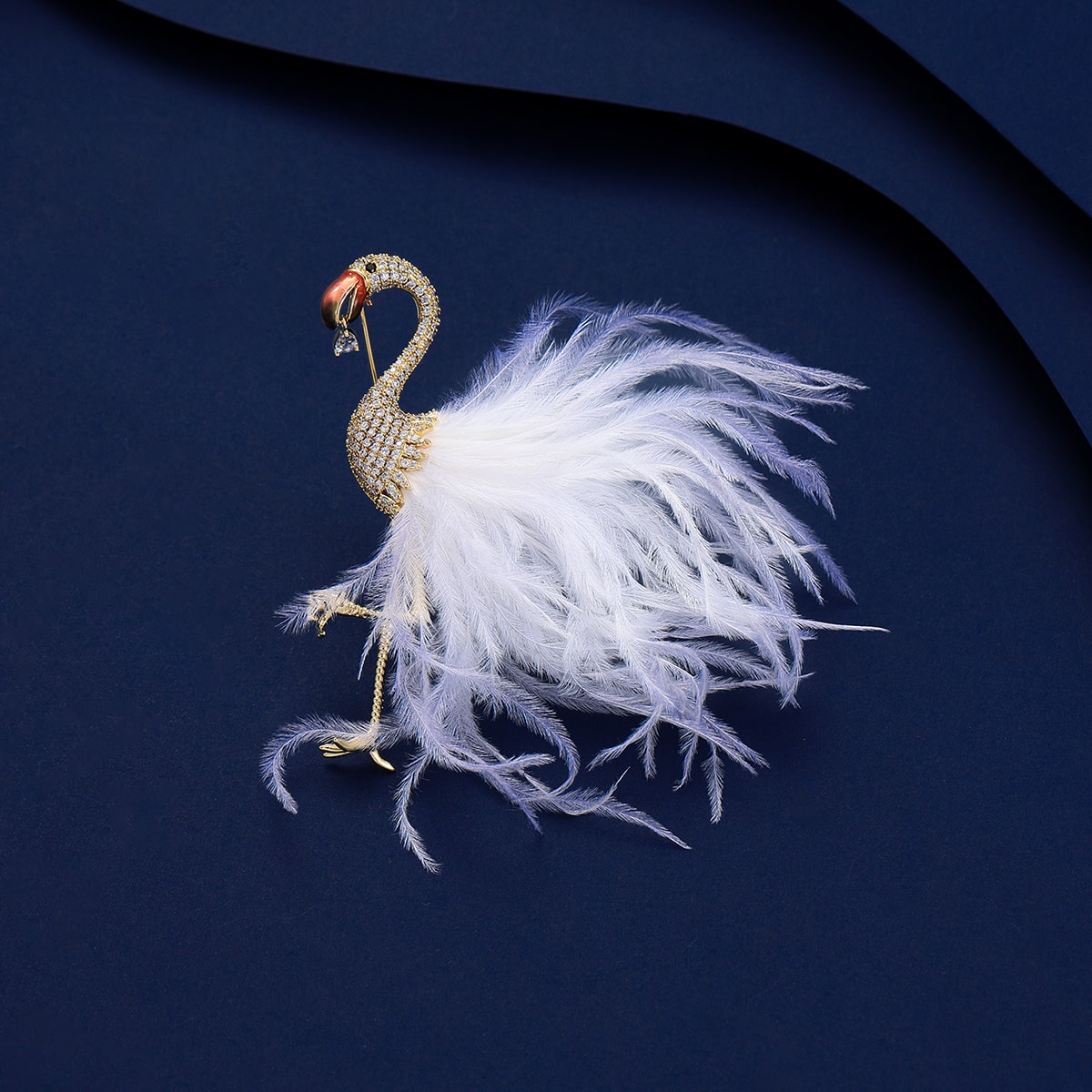 flamingo brooch with white feathers on blue background, adorned with cubic zirconia