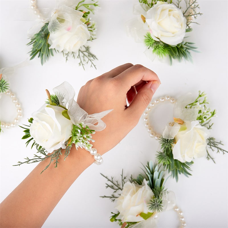 Embrace elegance with this stunning wrist corsage featuring an artificial white rose pearl bracelet. Let its beauty adorn your wrist, whispering tales of romance and sophistication.