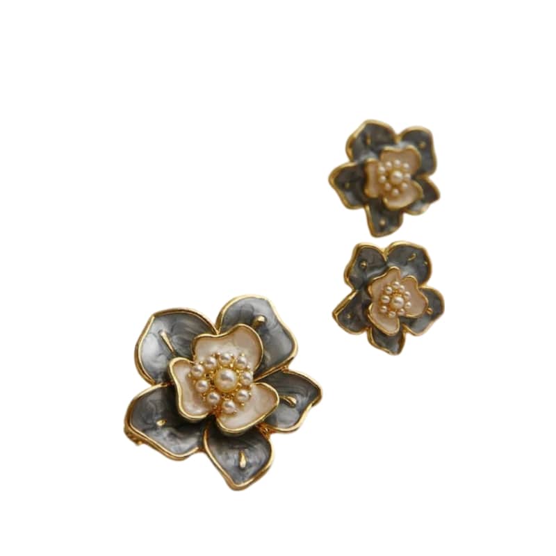 Golden and white flower earrings with grey petals edged in gold and pearls in the center