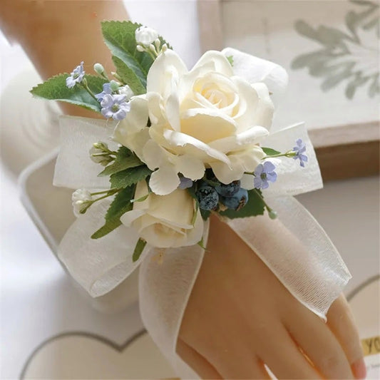 A delicate wrist corsage in ivory, meticulously handmade for elegance.