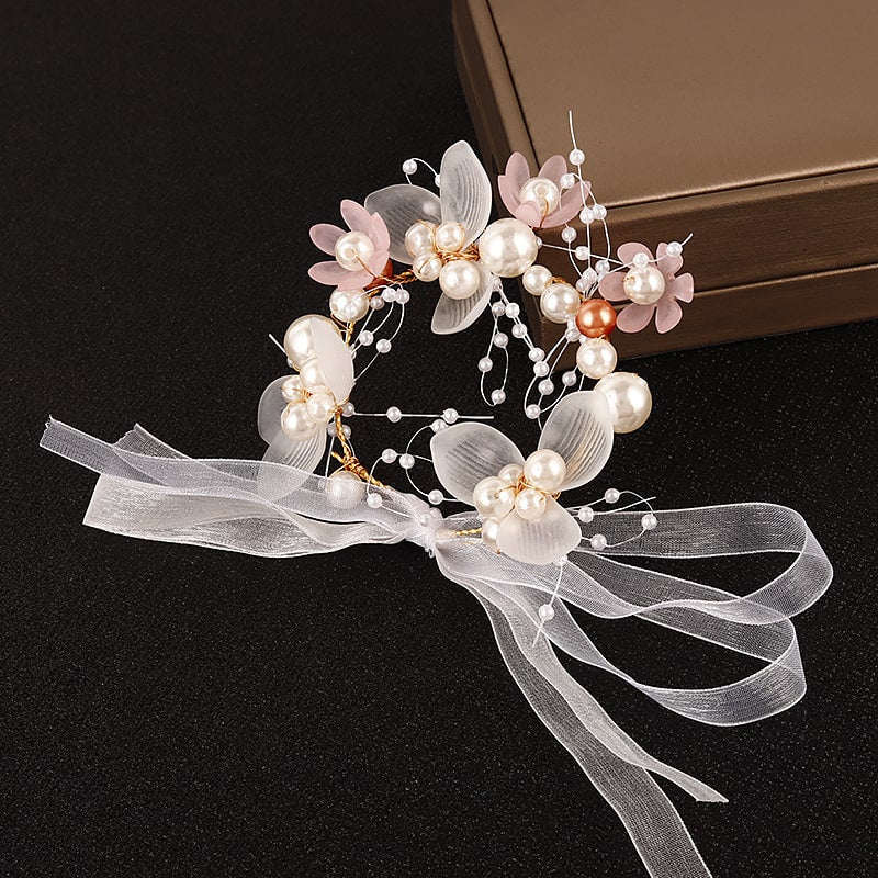 Pink and white pearls wrist corsage with delicate flowers