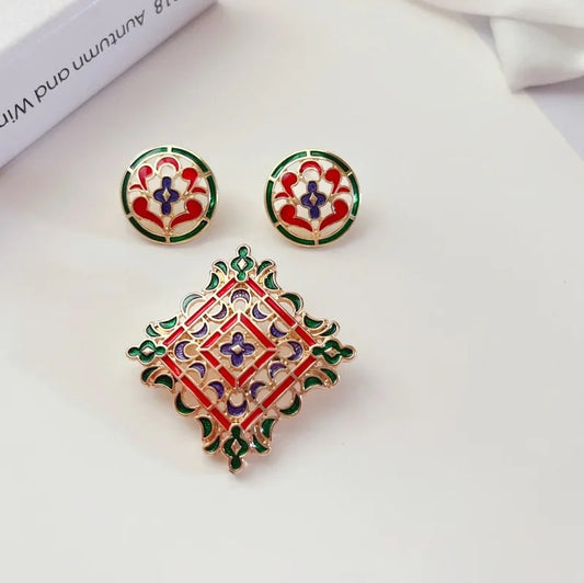 a pair of Retro Medieval Dropping Glaze Enamel  Earrings Set and a book on a table