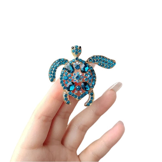 sparkling blue turtle brooch with intricate details