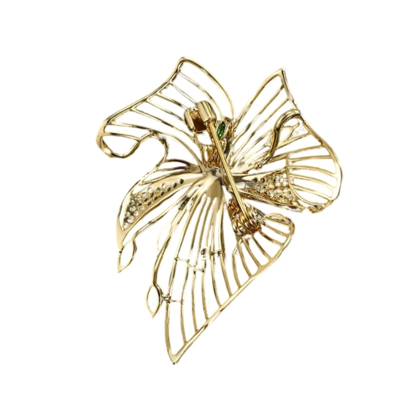 Golden brooch with emerald leaves, pearl, and rhinestones