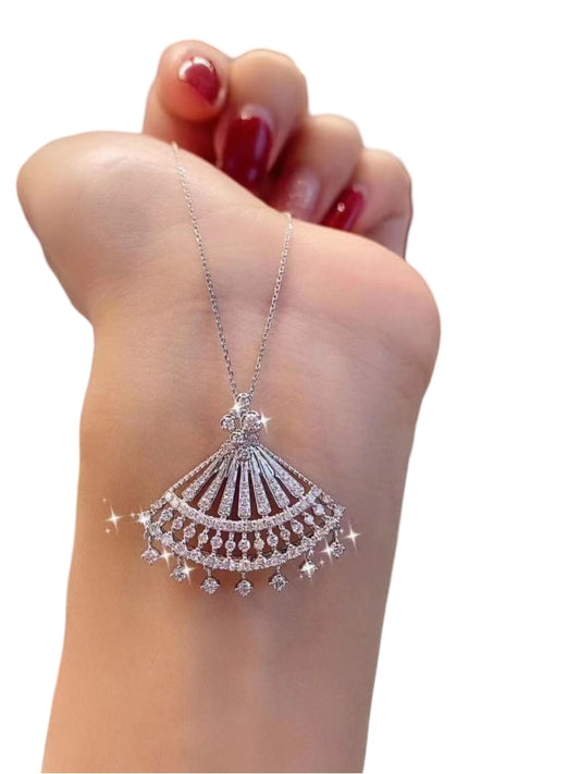 hand of a woman displaying a beautiful 925 silver necklace with a fan shaped pendant and white gemstones