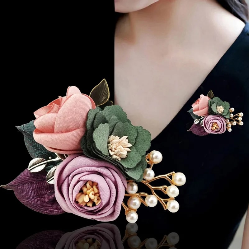 Let the romance blossom with this brooch, a fusion of fabric flowers and pearls, whispering tales of love
