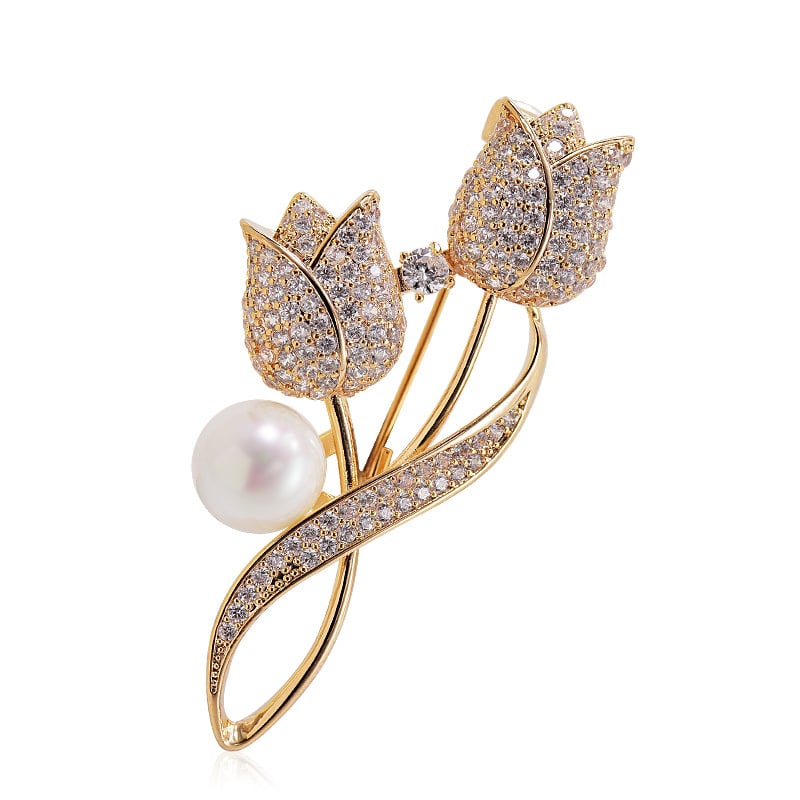 golden tulip flower brooch adorned with a luminous white pearl at its center