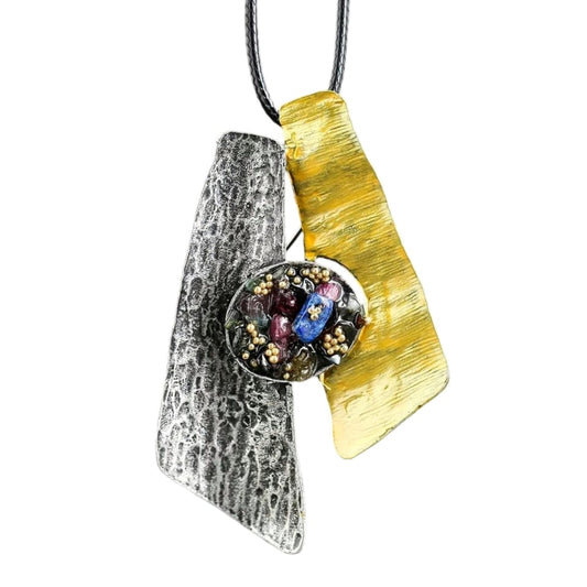 Pendant with golden and silver design, can be used as brooch or necklace. Adorned with gothic vintage gemstones, vibrant yet muted colors