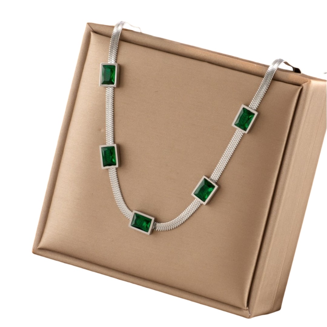 Green Stones Stainless Steel Necklace in a box, featuring cubic green stones on a silver chain for a unique and eye-catching look