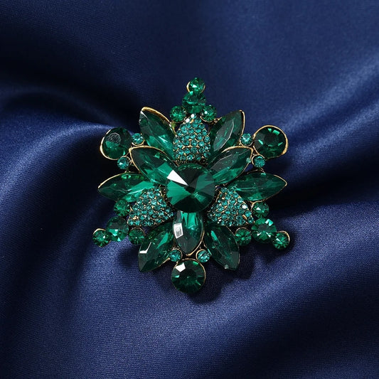 luxurious green crystal snowflake brooch with emerald stones, expertly designed and adorned with bright crystals