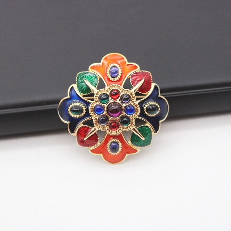 vibrant flower brooch with multi-coloured stones and intricate details