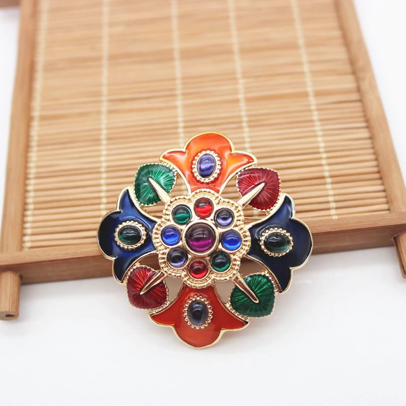 colorful flower design brooch with multi-coloured stones, intricate details, and vintage feel