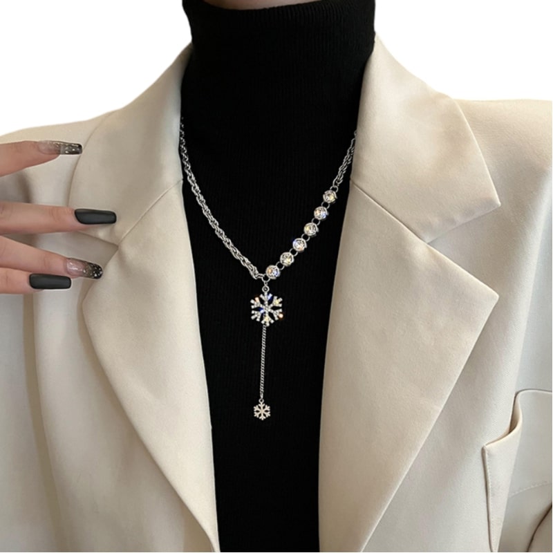 stylish woman in white blazer with flower necklace