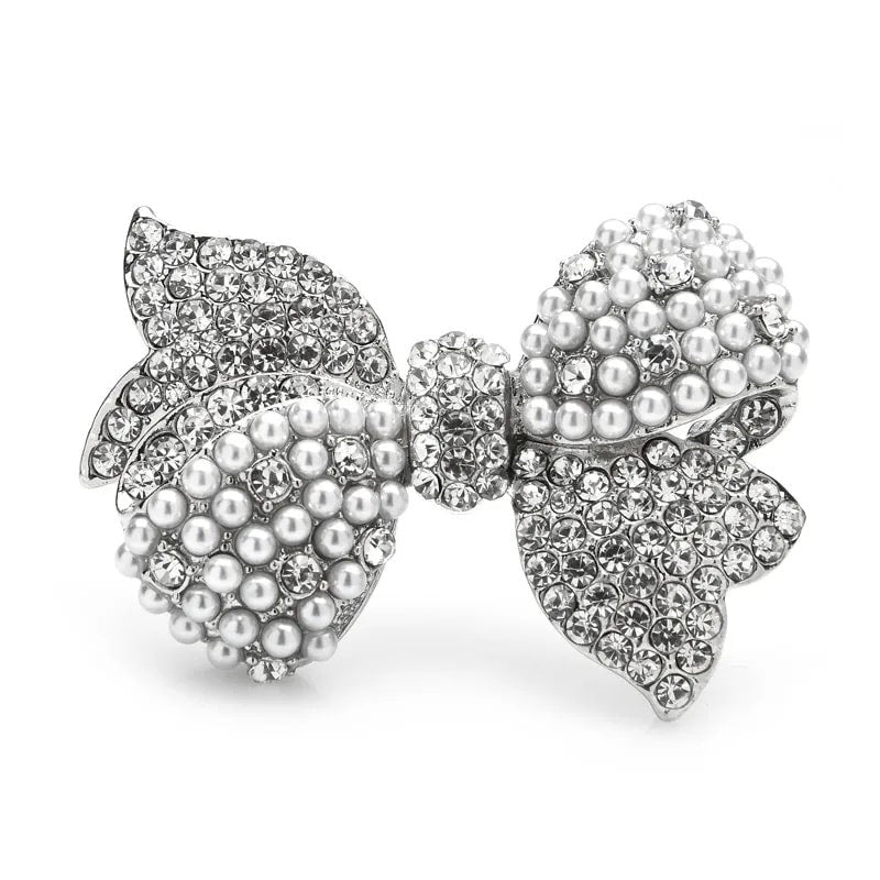 A dazzling brooch featuring sparkling rhinestones and elegant pearls, designed in the shape of a bowknot