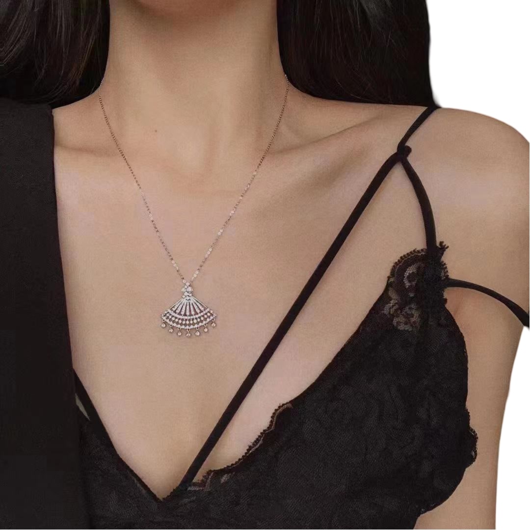 gorgeous fan shaped pendant necklace made of silver and set with dazzling white gemstones. An attractive and striking complement to any jewellery assortment
