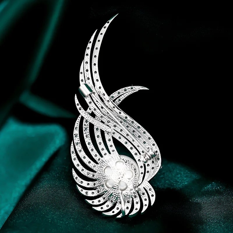 wing brooch adorned with cubic zirconia and large white diamond